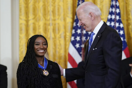 President Joe Biden awards the nation's highest civilian honor, the Presidential Medal of Freedom, to gymnast Simone Biles during a ceremony in the East Room of the White House in Washington, Thursday, July 7, 2022. Biles is the most decorated U.S. gymnast in history, winning 32 Olympic and World Championship medals, and is an advocate on issues including athletes' mental health, children in foster care and sexual assault victims. (AP Photo/Susan Walsh)