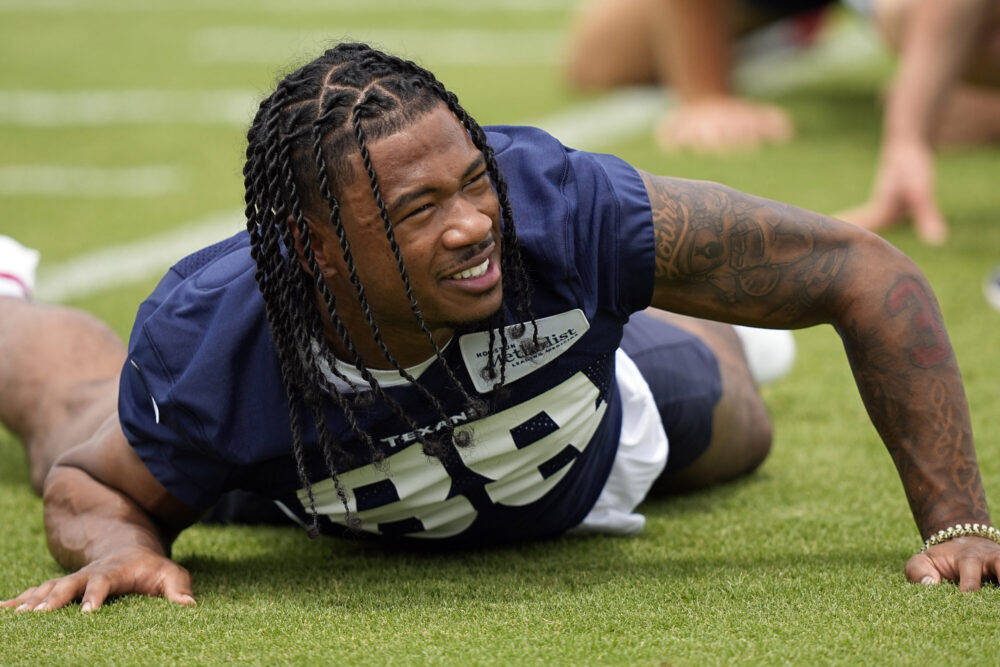 Houston Texans draft pick John Metchie III stretches during an NFL football rookie minicamp practice Friday, May 13, 2022, in Houston. (AP Photo/David J. Phillip)