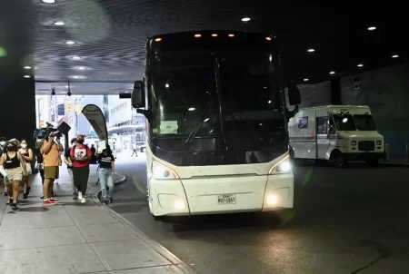 A bus carrying migrants from Texas arrives in New York City on Sunday, the second such bus to arrive in the city since Gov. Greg Abbott announced that New York would join Washington, D.C., as a destination for migrants being bused from the border.
