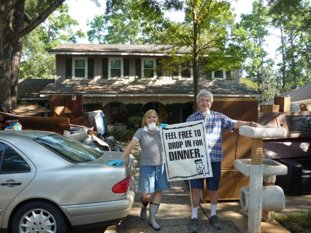 Landrum Wise and his wife, Lynnea, standing amid ruined appliances and furniture they'd removed from their home after it was inundated by water released from the Addicks and Barker Dams during Harvey.