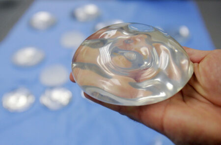 FILE - In this Dec. 11, 2006 file photo, a silicone gel breast implant is shown at Mentor Corp., a subsidiary of Johnson & Johnson, in Irving, Texas. On Wednesday, Oct. 27, 2021, U.S. health regulators finalized stronger warnings for breast implants, including a new requirement that people receive detailed information about their potential risks and complications before getting them.