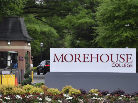 In this Friday, April 12, 2019 photo, people enter the campus of Morehouse College in Atlanta. One of the nation's top historically black colleges is cutting employee salaries and retirement contributions to increase student aid. The announcement Tuesday, Sept. 24, 2019, by Atlanta's Morehouse College comes months after billionaire Robert Smith promised to repay all student loans accumulated by Morehouse's class of 2019. That one-time gift will total $34 million after the college announced this week that Smith would also repay money borrowed by parents of Morehouse graduates. (AP Photo/Mike Stewart)