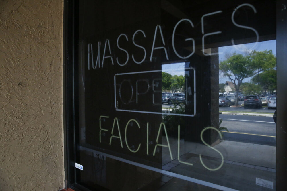 File: The front entrance of the Orchids of Asia Day Spa reads "massages, open and facials" in Jupiter, Fla., on Tuesday, March 26, 2019. 