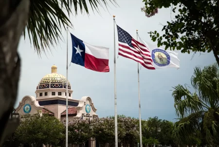 The city, state and national flags fly over city hall in Rio Grande City on June 17, 2021. Starr County, of which Rio Grande City is the seat, has more 100-degree days than any other county in Texas, according to a new study.