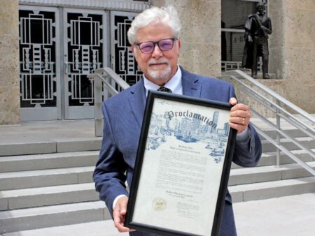 Architecture professor Bruce Race with the city of Houston proclamation naming August 23, 2022 as Ruffino Hills Redevelopment Community Day