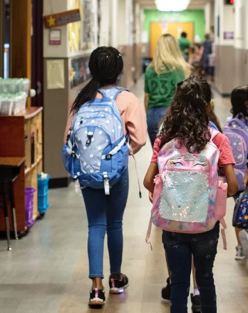 Children walk down a hallway at Live Oak Elementary School in August.