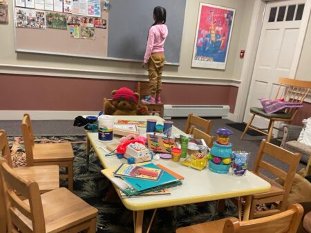 A young girl is shown staying at a shelter on Martha's Vineyard, Mass., after she and dozens of other migrants arrived by plane unannounced Wednesday.