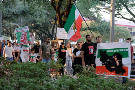 Demonstrators at City Hall in downtown Houston march in support of the protests that erupted in Iran triggered by the death of a 22-year-old woman, who died last month after being arrested by the “morality police” for allegedly violating the country’s strict dress code laws.