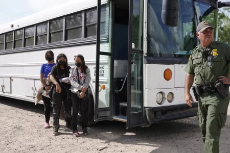 Migrants board a US Border Patrol bus for the detention center on the second day of the implementation of the Credible Fear and Asylum Processing Interim Final Rule on June 1, 2022 in La Joya, Texas, USA.