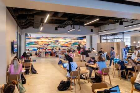 A crowd of customers mingles in the colorful and newly renovated Cougar Grounds coffee shop