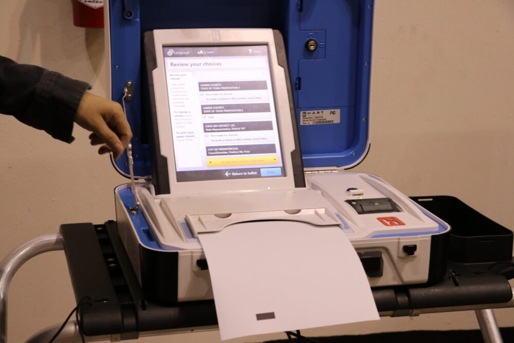 A sample ballot is placed in the voting machine as a demonstration for how it work on election day.