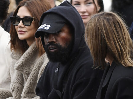 US rapper Kanye West (C), attends the Givenchy Spring-Summer 2023 fashion show during the Paris Womenswear Fashion Week, in Paris, on October 2, 2022. (Photo by JULIEN DE ROSA / AFP) (Photo by JULIEN DE ROSA/AFP via Getty Images)