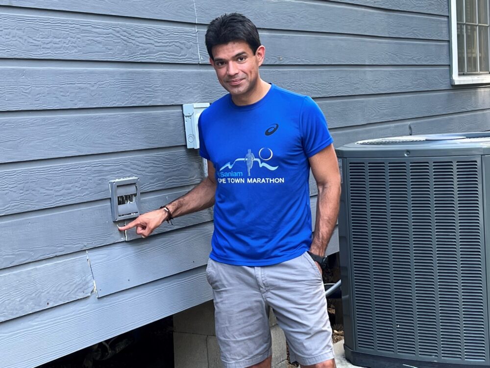 Juan Antonio Sorto, pointing to the high-water mark for Hurricane Harvey on his house