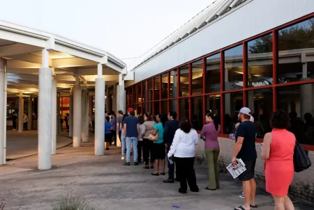 Evening voters queue up in a long line before polls close Tuesday at the Metropolitan Multi-Service Center in Houston.