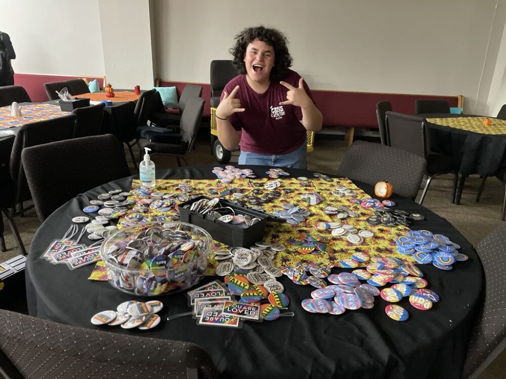 Gabe at Cinco Ranch's mobie night social with LGBTQ pins that the group gave away. 