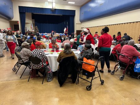 Seniors at Acres Homes attend a Houston Police Departmeent event where they receive meals and heaters ahead of the chilly holiday.