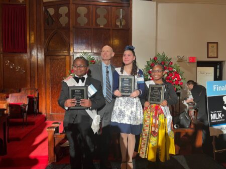 Left to right: Xavier Holmes Jr. (Third runner up)  Windsor Elementary, Claude Treece with the Foley Law Firm, Kandence Smith (first place), Law Elementary, Journey Sensley (Second Place) Young Elementary .