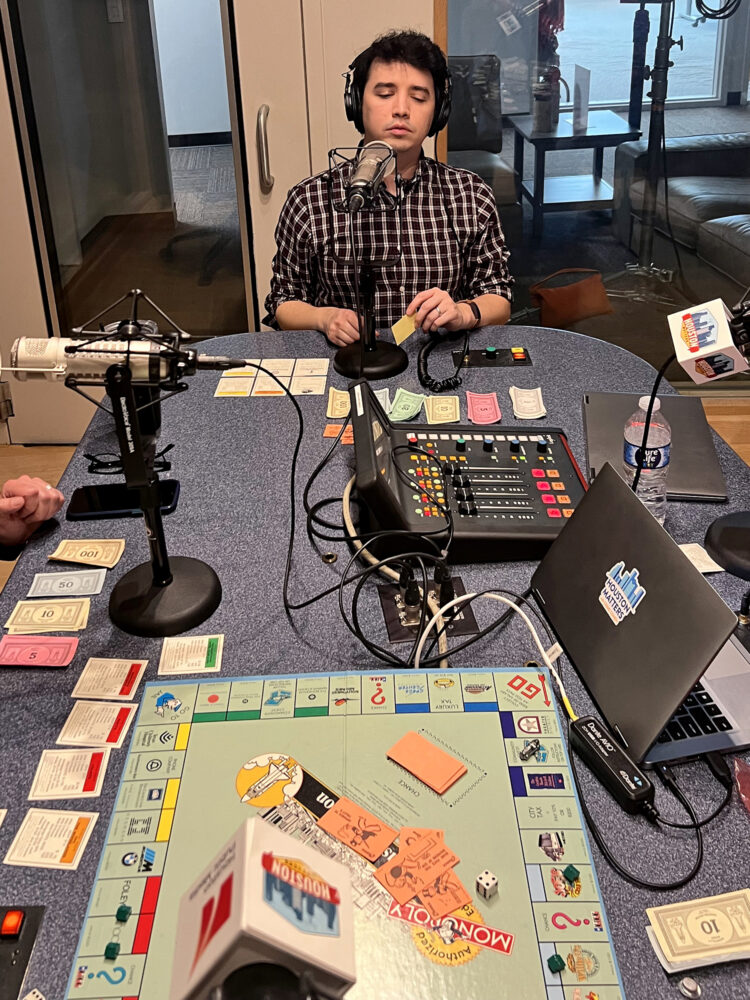 Houston Matters producer Joshua Zinn ponders his next move as he plays Monopoly Houston Edition.