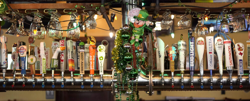Beer taps are idle at Mo's Irish Pub on St. Patrick's Day, Tuesday, March 17, 2020, in Houston. Houston area bars and restaurants have been ordered to follow new restrictions for the next 15 days in an effort to curb coronavirus exposure. Bars and nightclubs must close and restaurants can only be open for delivery, pickup and drive-thru services. No in-dining service is allowed. 