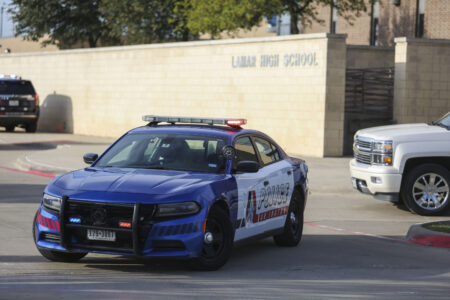 Arlington police block Lamar High School after a shooting Monday, March 20, 2023, in Arlington. Two students were injured and the shooter is in custody.
