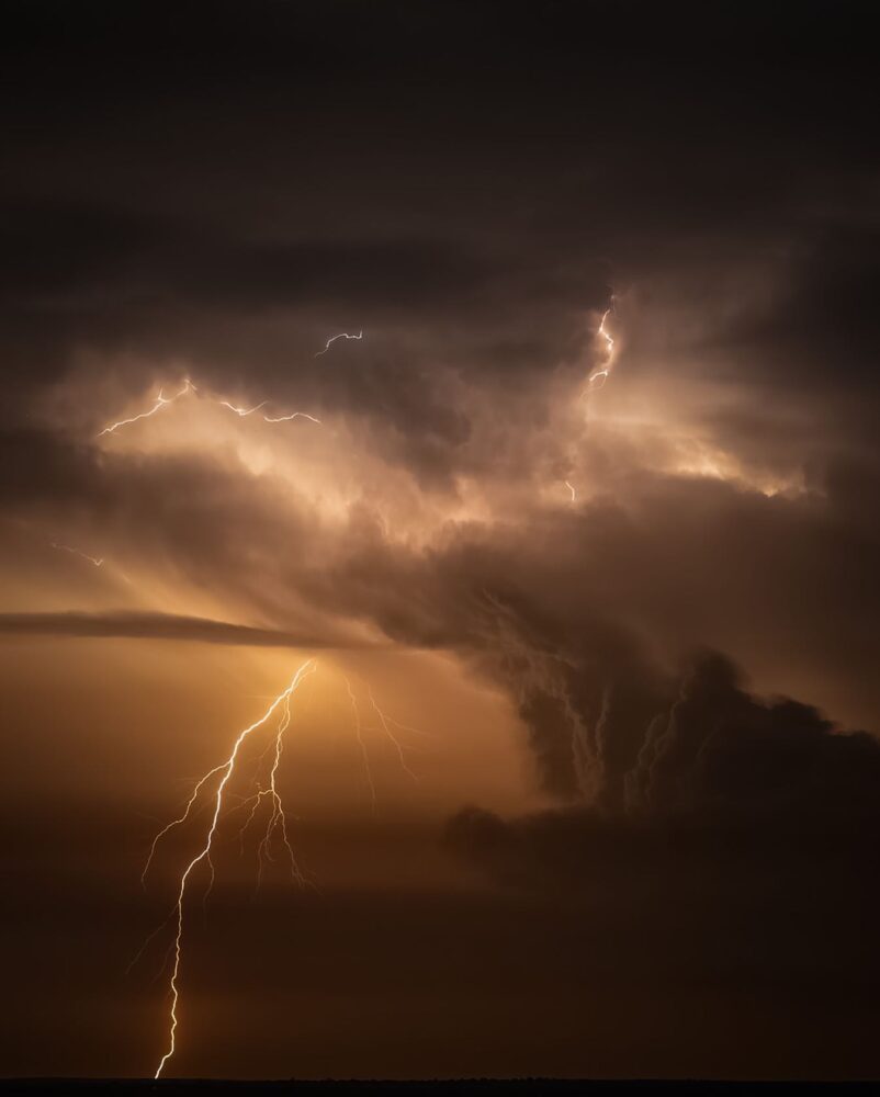 A photo of lightning and stormy weather from a distance.