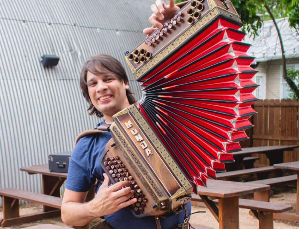 Alex Meixner holding one of his accordions.