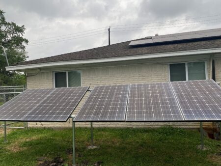 Students in Efrem Jernigan's solar class install solar panels in a Sunnyside backyard.