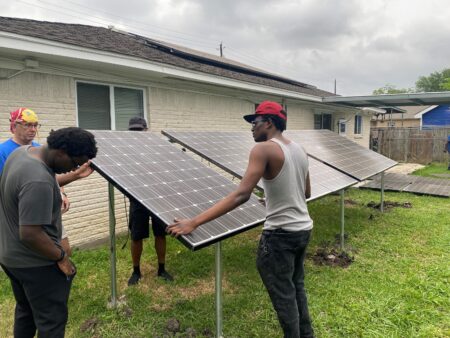 Students in Efrem Jernigan's class learn how to install solar panels.