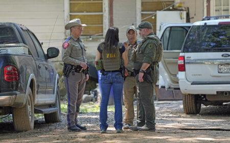Law enforcement officials work Sunday, April 30, 2023, in the neighborhood where a mass shooting occurred Friday night, in Cleveland, Texas. The search for a Texas man who allegedly shot his neighbors after they asked him to stop firing off rounds in his yard stretched into a second day Sunday, with authorities saying the man could be anywhere by now. Francisco Oropeza, 38, fled after the shooting Friday night that left several people dead, including a young boy.