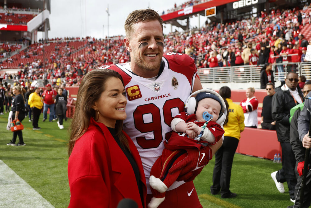 FILE - Arizona Cardinals defensive end J.J. Watt (99) poses with his wife, Kealia, and their son, Koa, before an NFL football game against the San Francisco 49ers in Santa Clara, Calif., Sunday, Jan. 8, 2023. Former NFL star J.J. Watt and his wife, Kealia, have announced an investment in the English soccer club Burnley, which recently earned promotion to the Premier League. The two announced their investement on Monday, May 1, 2023, with J.J. joking that he's “officially retiring from retirement.” (AP Photo/Jed Jacobsohn, File)