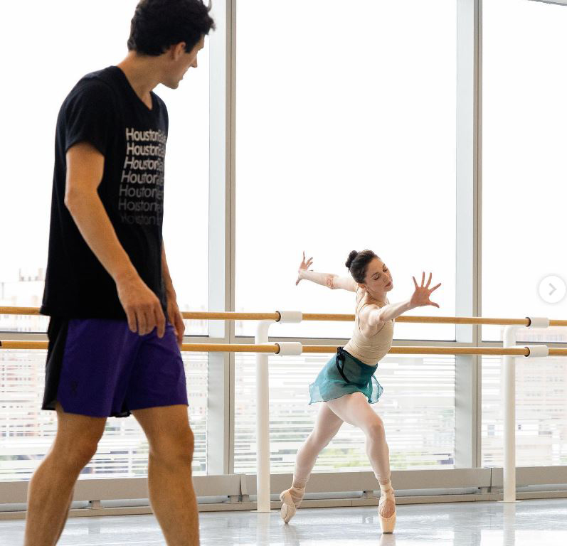 A man in a dance studio with a ballet dancer