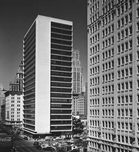 A black-and-white photo of a highrise building in downtown Houston