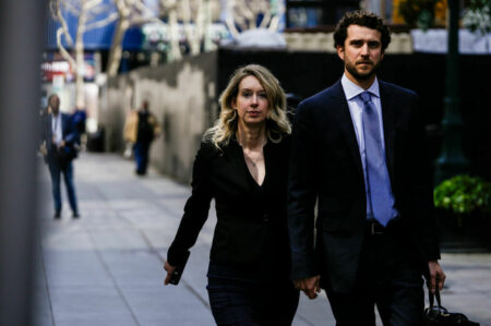 SAN JOSE, CA - MARCH 17: Former Theranos CEO Elizabeth Holmes alongside her boyfriend Billy Evans, walks back to her hotel following a hearing at the Robert E. Peckham U.S. Courthouse on March 17, 2023 in San Jose, California. Holmes appeared in court for a restitution hearing. (Photo by Philip Pacheco/Getty Images)