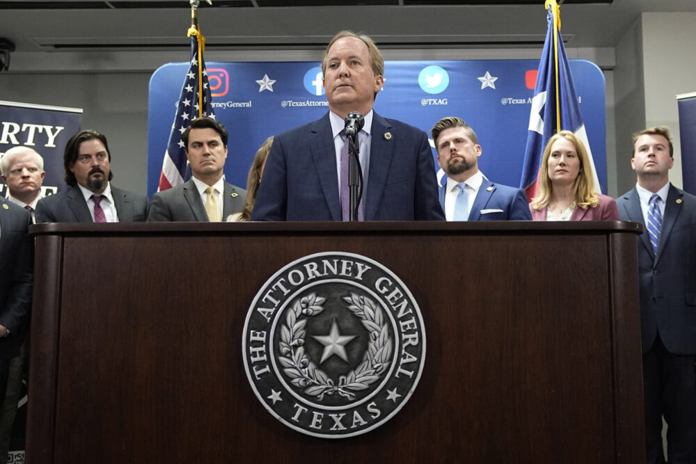 Texas state Attorney General Ken Paxton, center, makes a statement at his office in Austin, Texas, Friday, May 26, 2023.