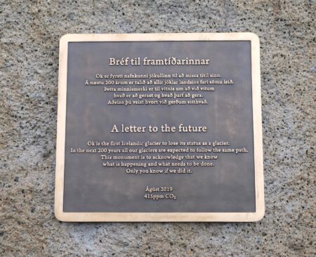 Photo of plaque with the words: A letter to the future. Ok is the first Icelandic glacier to lose its status as a glacier. In the next 200 years all our glaciers are expected to follow the same path. This monument is to acknowledge that we know what is happening and what needs to be done. Only you know if we did it.