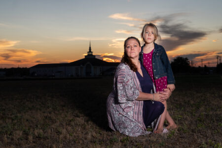Still photo of mom and her transgender daughter in front of a church