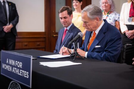 Governor Greg Abbott signing Senate Bill 15, effectively banning trans athletes' participation in college sports, June 15, 2023.