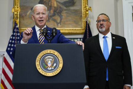 
President Joe Biden (left) speaks about student loan debt forgiveness at the White House on Aug. 24 with Education Secretary Miguel Cardona.