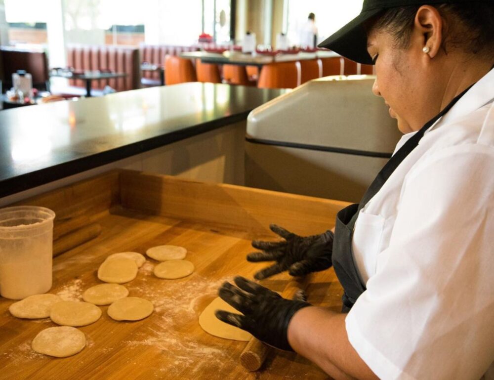 An employee makes the homemade flour tortillas at Candente which use the fat from smoked brisket