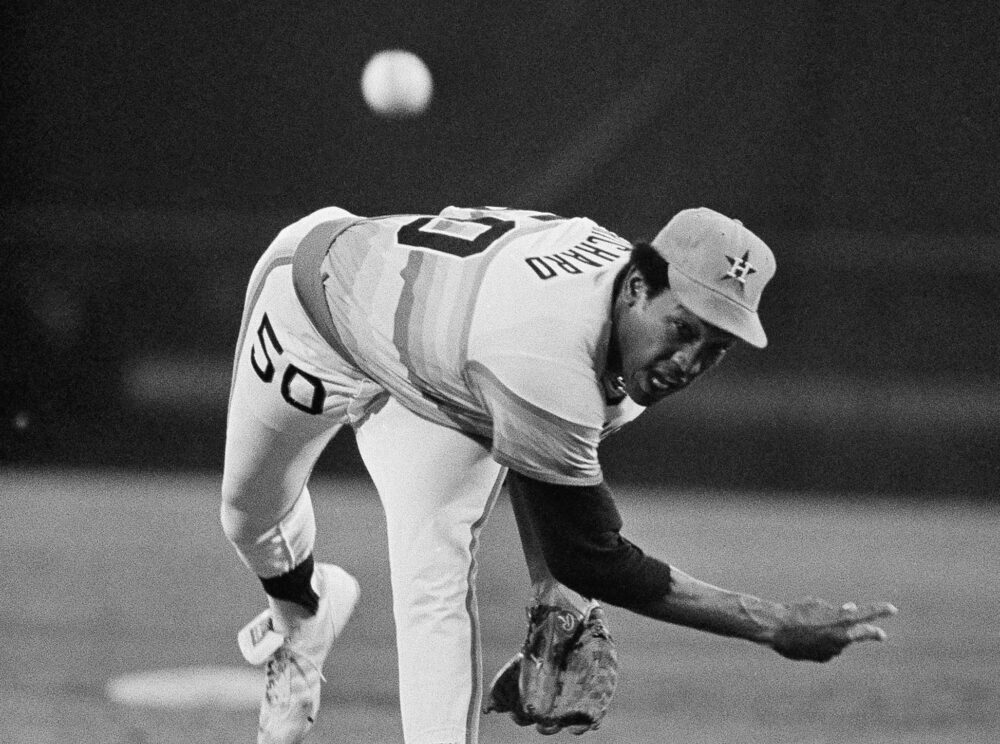 A black-and-white photo of Astros pitcher J.R. Richard throwing a baseball in 1978