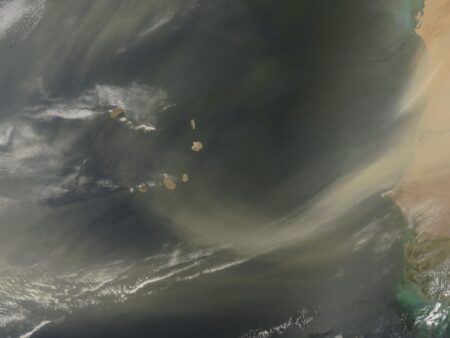 This June 21, 2009, file photo from the NASA Earth Observatory shows Saharan sand blowing off the coasts of Mauritania and Senegal. Although this image shows dust immediately off the coast of West Africa, a layer of dust from storms such as this often travels virtually intact to the other side of the Atlantic. This layer of dry, hot, dusty air is called the Saharan Air Layer.