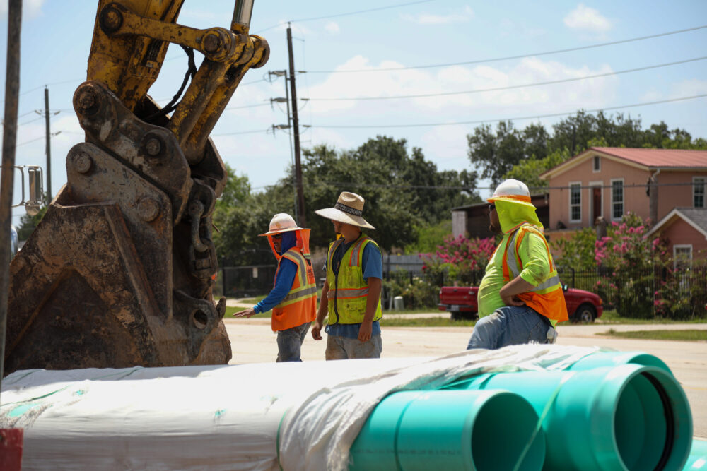 Construction workers at the Trammel Fresno Improvement Project construction site wear protective gear to keep cool during the extreme heat in the greater Houston area. 