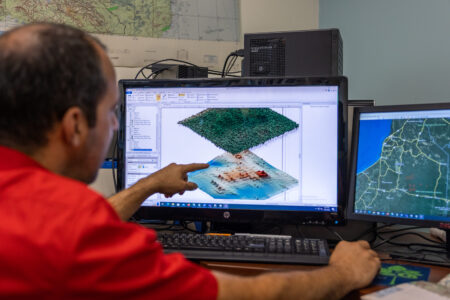 Juan Fernandez-Diaz looking at maps on his computer. NCALM with Lidar technology finds remains of ancient mayan city.