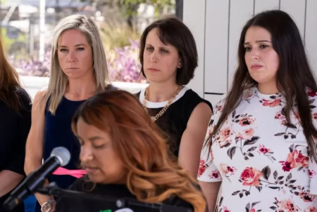 Amanda Zurawski, Molly Duane and Ashley Brandt look on as Samantha Casiano addresses the press following the first day of testimony for Zurawski v. State of Texas in Austin on July 19.
