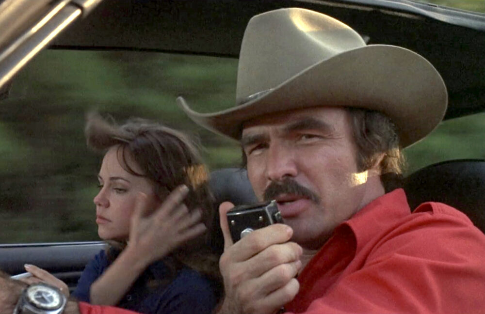 Burt Reynolds using a CB radio alongside Sally Field in the 1977 movie "Smokey and the Bandit."