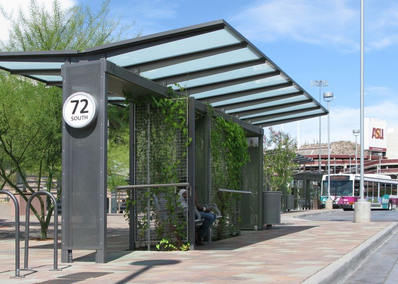 Cities around the world are updating their bus shelters to better protect riders from heat as climate change is warming the planet. This shelter in Tempe, Arizona has vines growing on an open screen to allow air flow and transpiration to cool the shelter.