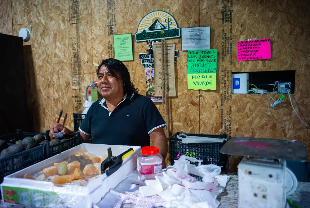 A. Carrasco, 52, stands at the counter of his store on Oct. 2 in New Caney. Carrasco said his family’s business began as a traveling fruit stand before they opened the shop in March.