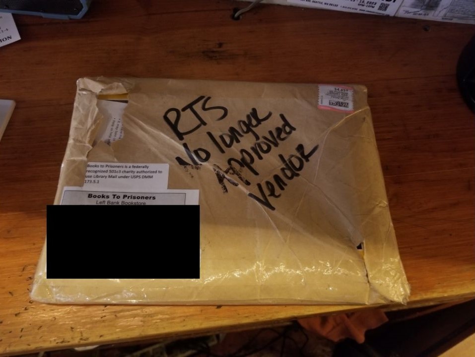A returned package sent from Seattle-based Books to Prisoners to an inmate in Texas. A name and address have been covered for privacy.