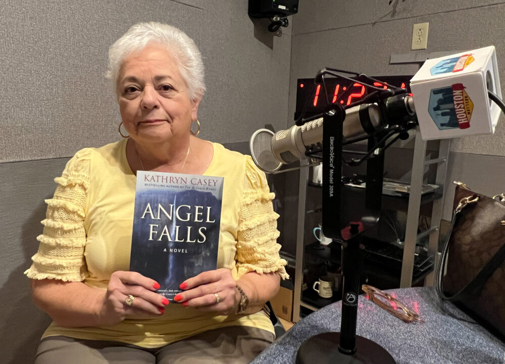 Houston writer Kathryn Casey holding her historical fiction novel, Angel Falls.