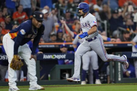 Texas Rangers' Marcus Semien scores on a throwing error by Houston Astros' Framber Valdez during the first inning of Game 2 of the baseball AL Championship Series Monday, Oct. 16, 2023, in Houston. (AP Photo/David J. Phillip)